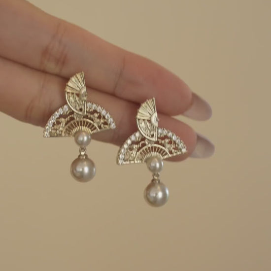 Video view of ornate drop high-lustre freshwater pearl earrings styled for wedding guest looks