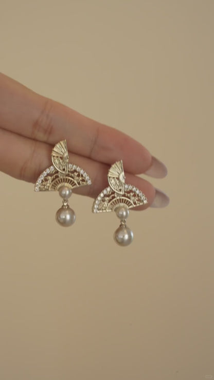 Video view of ornate drop high-lustre freshwater pearl earrings styled for wedding guest looks