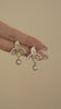 Video view of ornate drop high-lustre freshwater pearl earrings styled for wedding guest looks