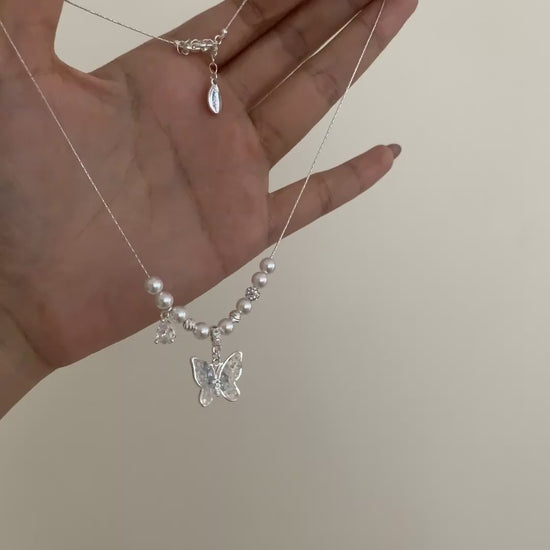 Video view of butterfly pendant high-lustre freshwater pearl necklace styled for weddings