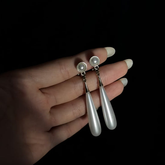 Video view of teardrop high-lustre freshwater pearl earrings styled for wedding guest looks