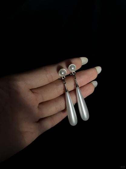 Video view of teardrop high-lustre freshwater pearl earrings styled for wedding guest looks