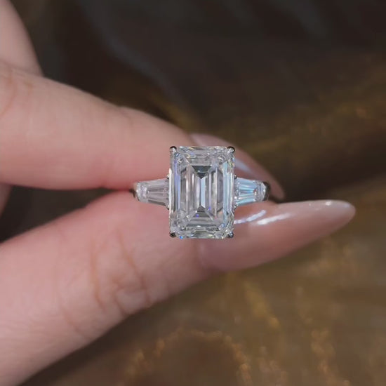 Video of lab-grown diamond emerald cut trilogy engagement ring for timeless proposals