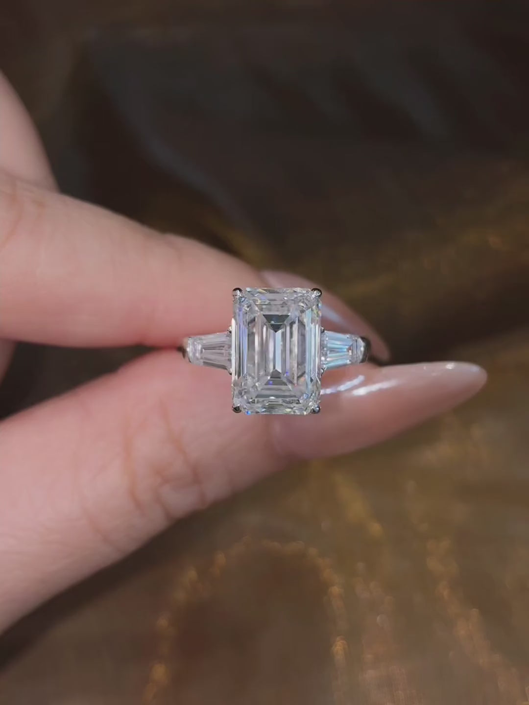 Video of lab-grown diamond emerald cut trilogy engagement ring for timeless proposals