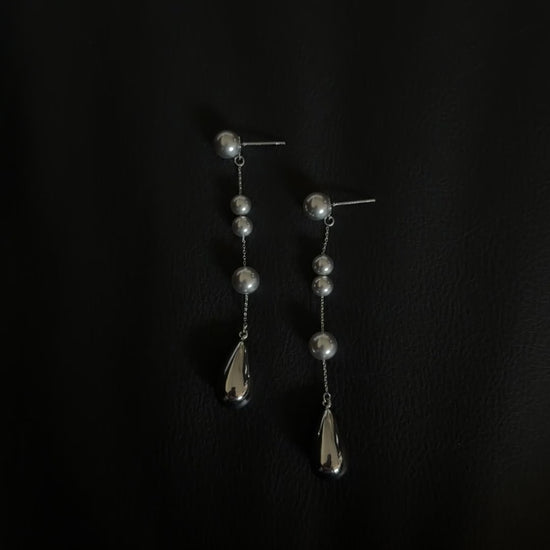 Video view of silver-tone drop high-lustre freshwater pearl earrings styled for wedding guest looks