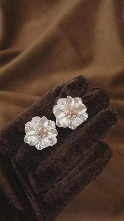 Video view of white flower high-lustre freshwater pearl earrings styled for wedding guest looks