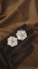 Video view of white flower high-lustre freshwater pearl earrings styled for wedding guest looks