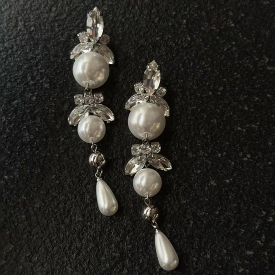 Video view of long pearl drop high-lustre freshwater pearl earrings styled for wedding guest looks