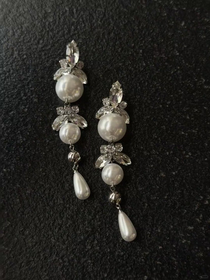Video view of long pearl drop high-lustre freshwater pearl earrings styled for wedding guest looks