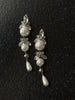 Video view of long pearl drop high-lustre freshwater pearl earrings styled for wedding guest looks