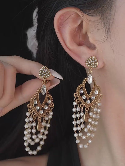 Video view of chandelier high-lustre freshwater pearl earrings styled for wedding guest looks