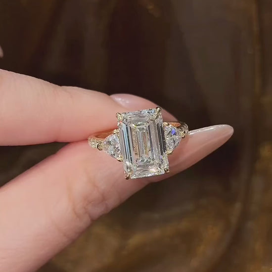 Video of lab-grown diamond emerald cut three stone ring for elegant proposals