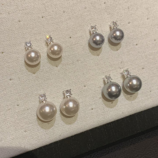 Video view of halo drop high-lustre freshwater pearl earrings styled for wedding guest looks