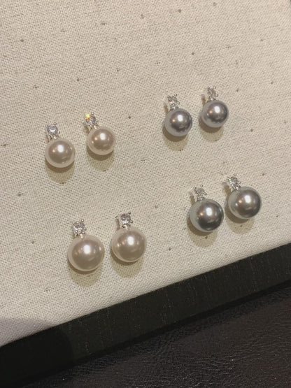 Video view of halo drop high-lustre freshwater pearl earrings styled for wedding guest looks