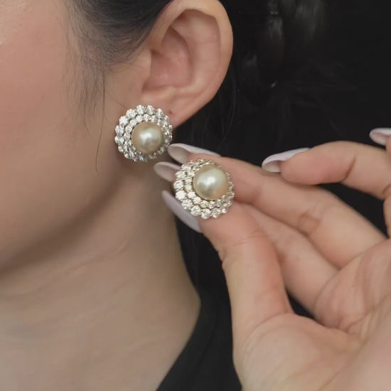Video view of halo stud high-lustre freshwater pearl earrings styled for wedding guest looks