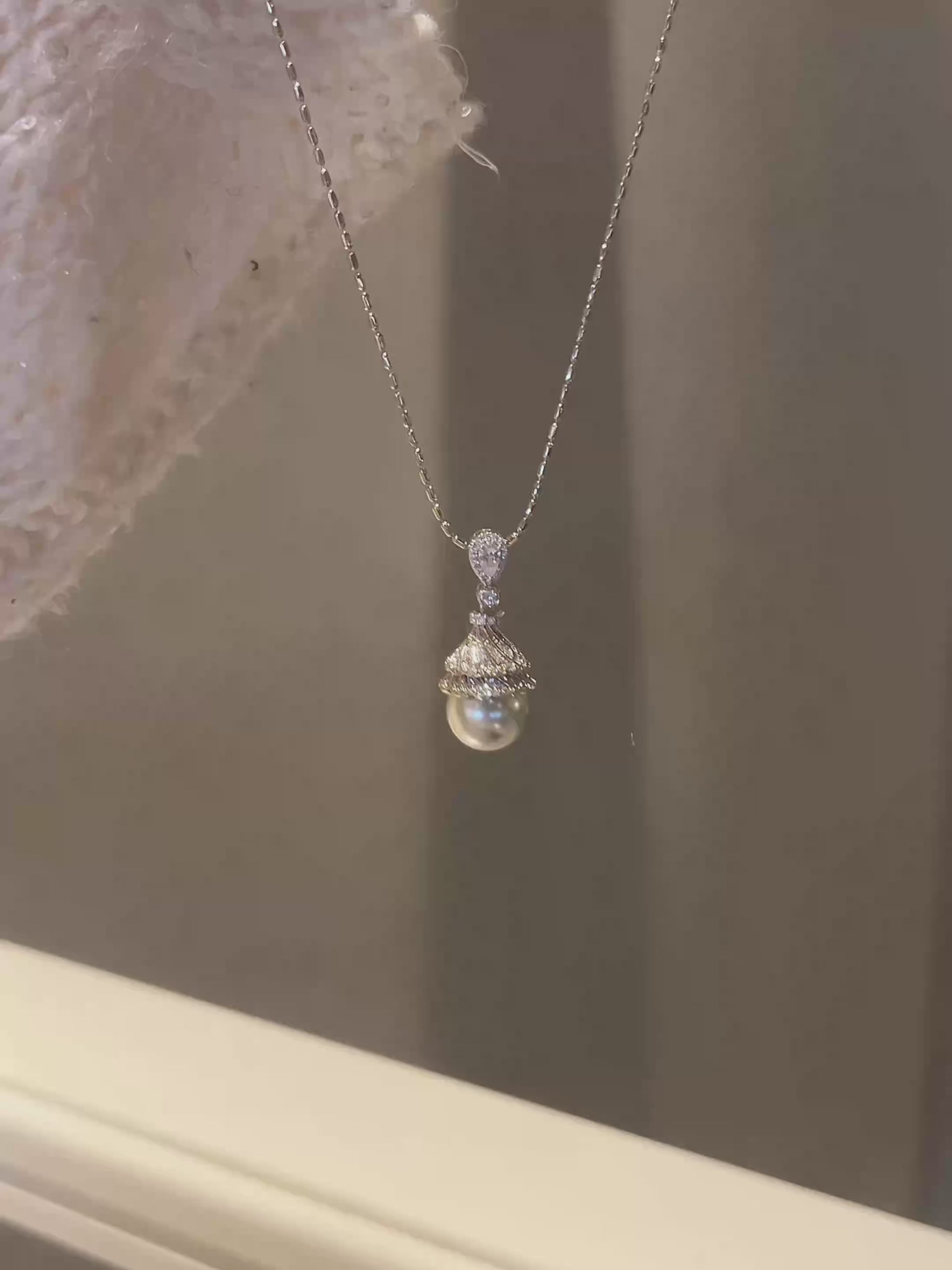 Video view of luminous pendant high-lustre freshwater pearl necklace styled for weddings
