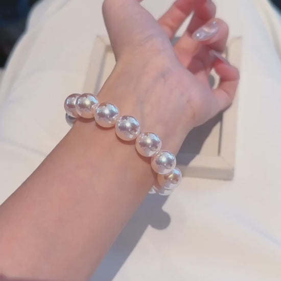 Video view of white strand high-lustre freshwater pearl bracelet styled for bridal styling