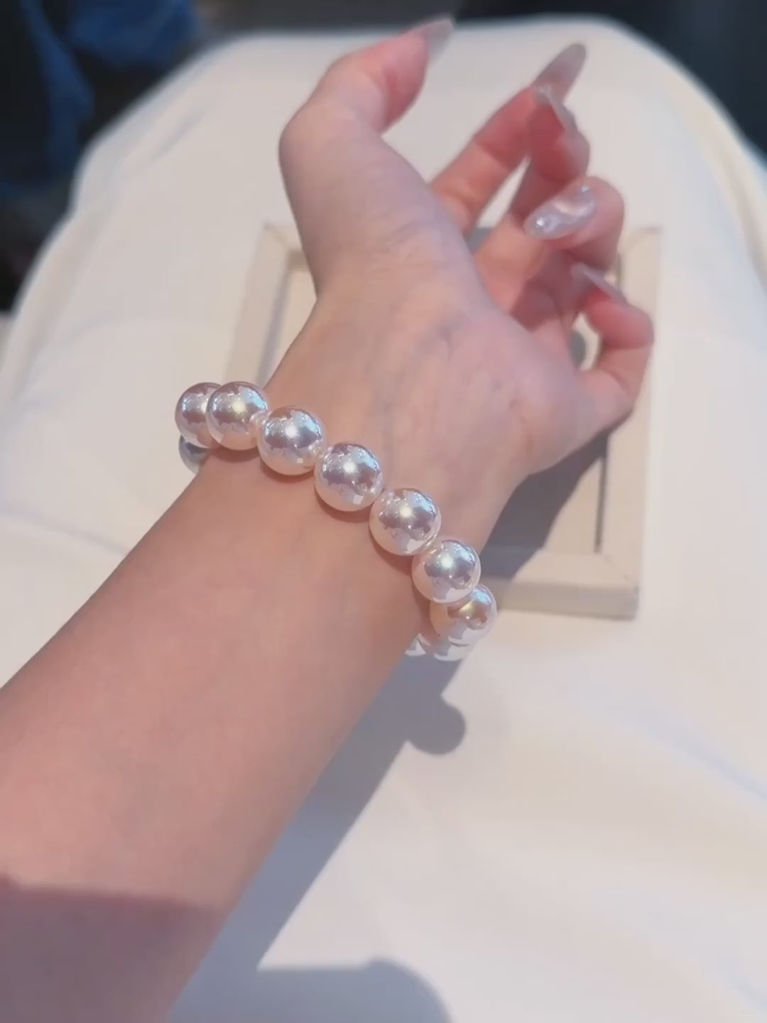 Video view of white strand high-lustre freshwater pearl bracelet styled for bridal styling