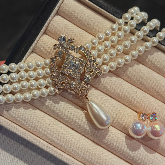 Video view of baroque drop high-lustre freshwater pearl earrings styled for wedding guest looks