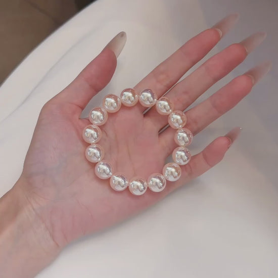 Video view of pink pearl high-lustre freshwater pearl bracelet styled for bridal styling