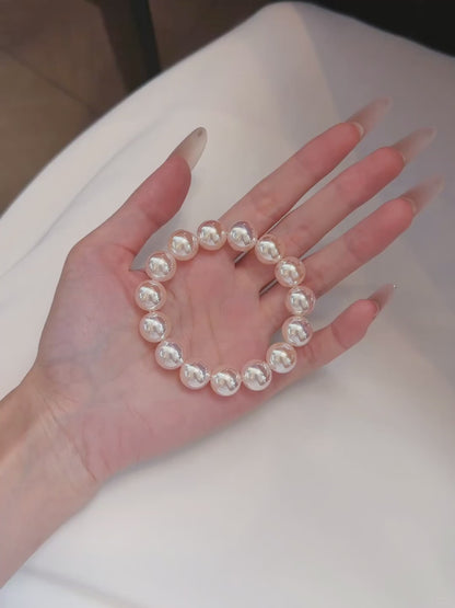Video view of pink pearl high-lustre freshwater pearl bracelet styled for bridal styling
