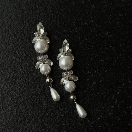 Video view of long pearl drop high-lustre freshwater pearl earrings styled for wedding guest looks