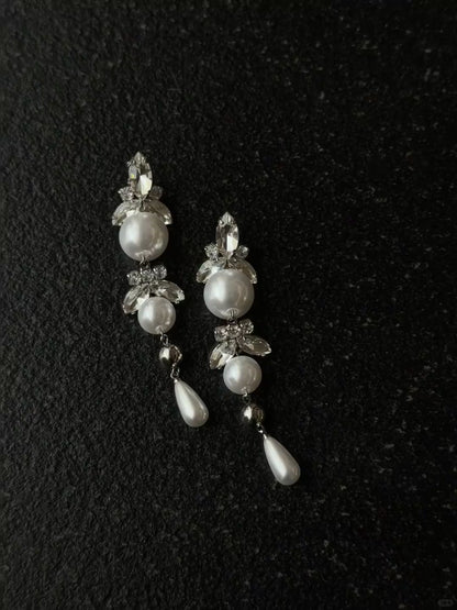 Video view of long pearl drop high-lustre freshwater pearl earrings styled for wedding guest looks