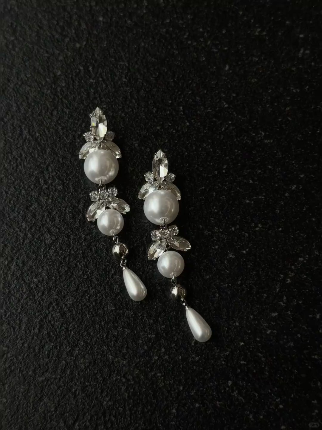 Video view of long pearl drop high-lustre freshwater pearl earrings styled for wedding guest looks