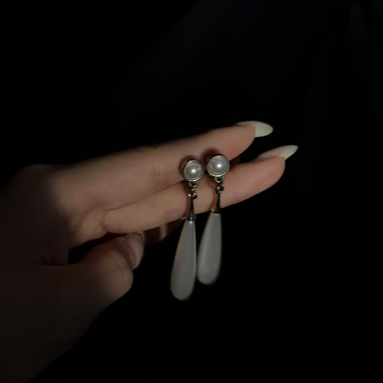 Video view of teardrop high-lustre freshwater pearl earrings styled for wedding guest looks