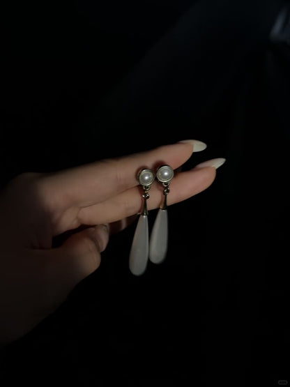 Video view of teardrop high-lustre freshwater pearl earrings styled for wedding guest looks