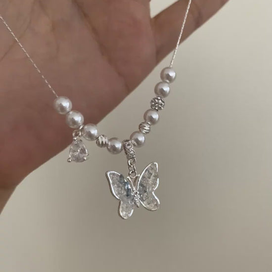Video view of butterfly pendant high-lustre freshwater pearl necklace styled for weddings