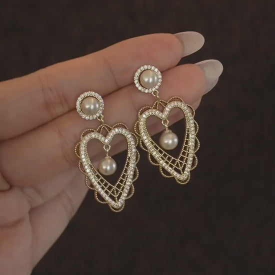 Video view of lace heart high-lustre freshwater pearl earrings styled for wedding guest looks