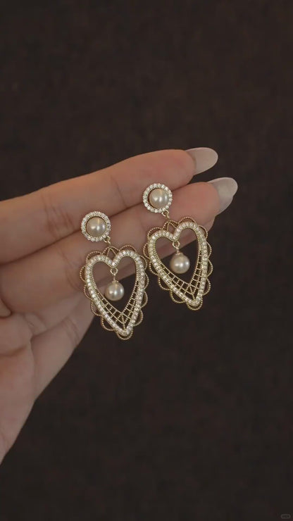 Video view of lace heart high-lustre freshwater pearl earrings styled for wedding guest looks