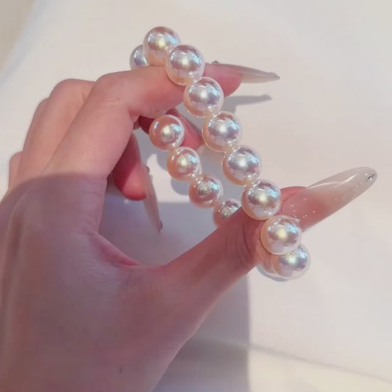 Video view of white strand high-lustre freshwater pearl bracelet styled for bridal styling