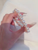 Video view of white strand high-lustre freshwater pearl bracelet styled for bridal styling