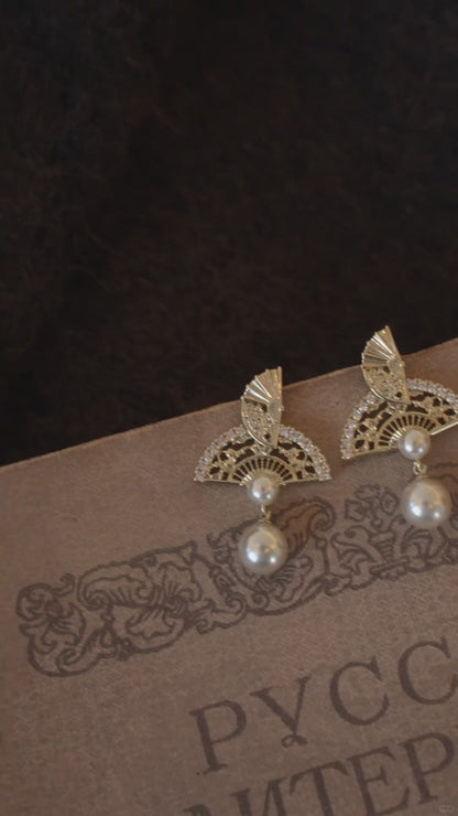 Video view of ornate drop high-lustre freshwater pearl earrings styled for wedding guest looks