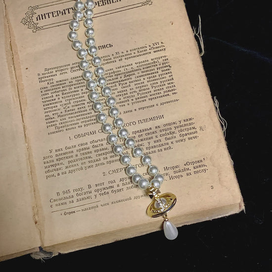 Video view of orb motif high-lustre freshwater pearl necklace styled for weddings
