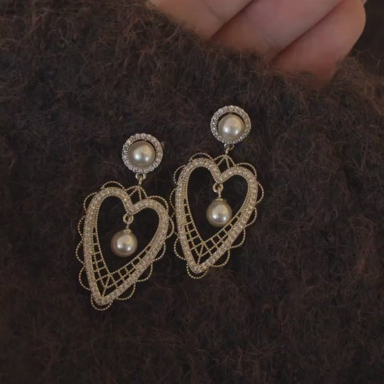 Video view of lace heart high-lustre freshwater pearl earrings styled for wedding guest looks