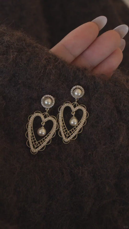 Video view of lace heart high-lustre freshwater pearl earrings styled for wedding guest looks