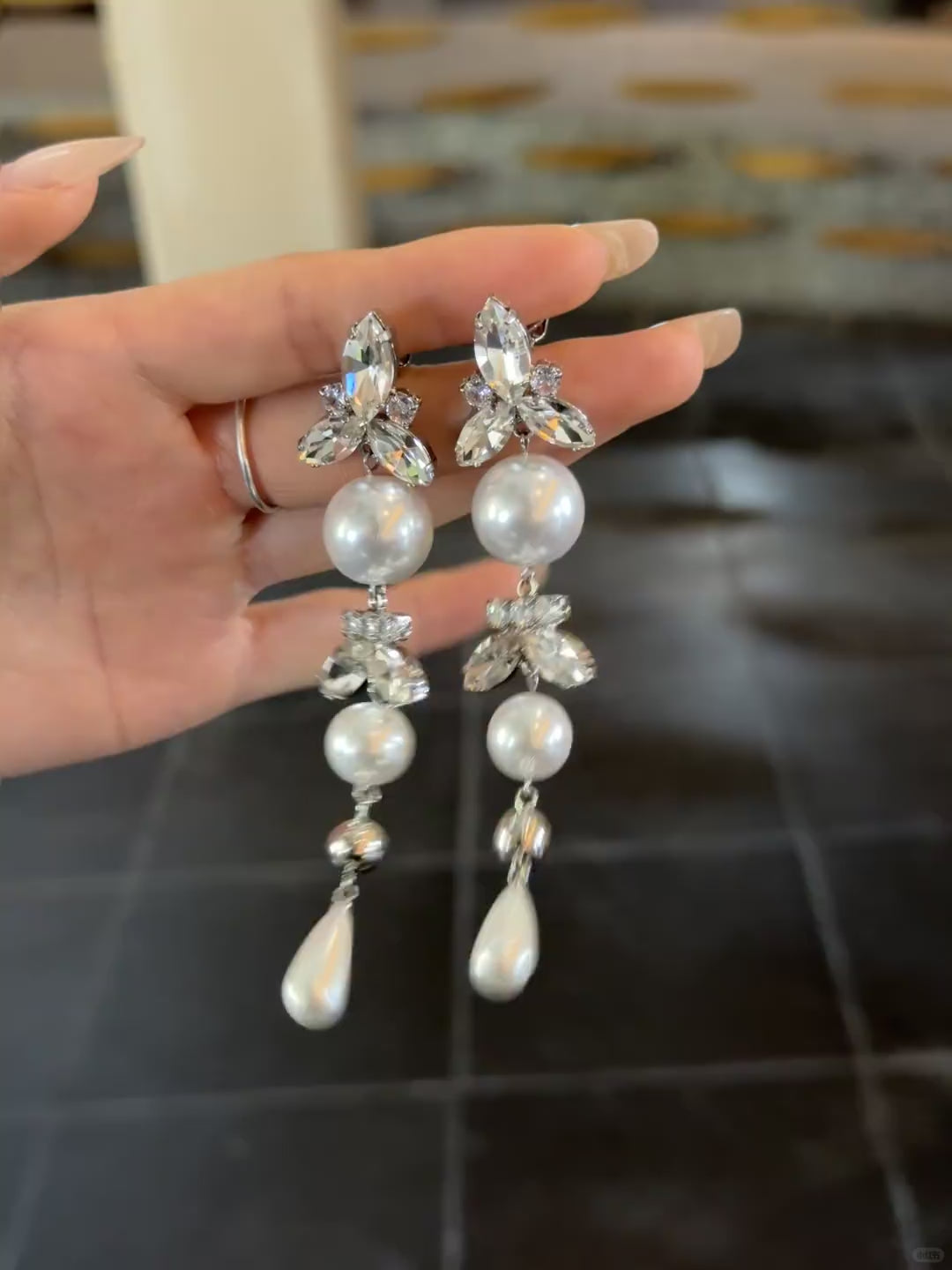Video view of long pearl drop high-lustre freshwater pearl earrings styled for wedding guest looks