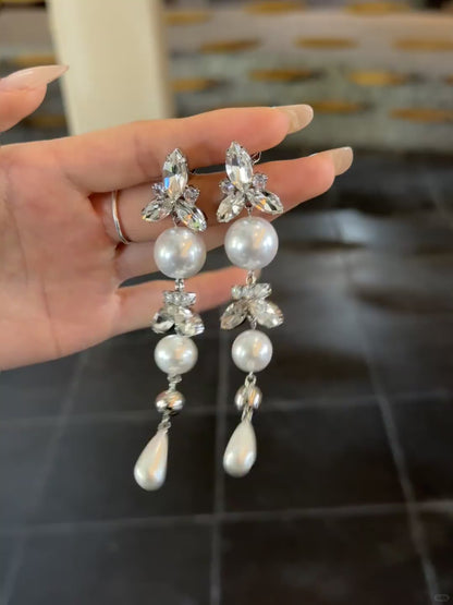 Video view of long pearl drop high-lustre freshwater pearl earrings styled for wedding guest looks