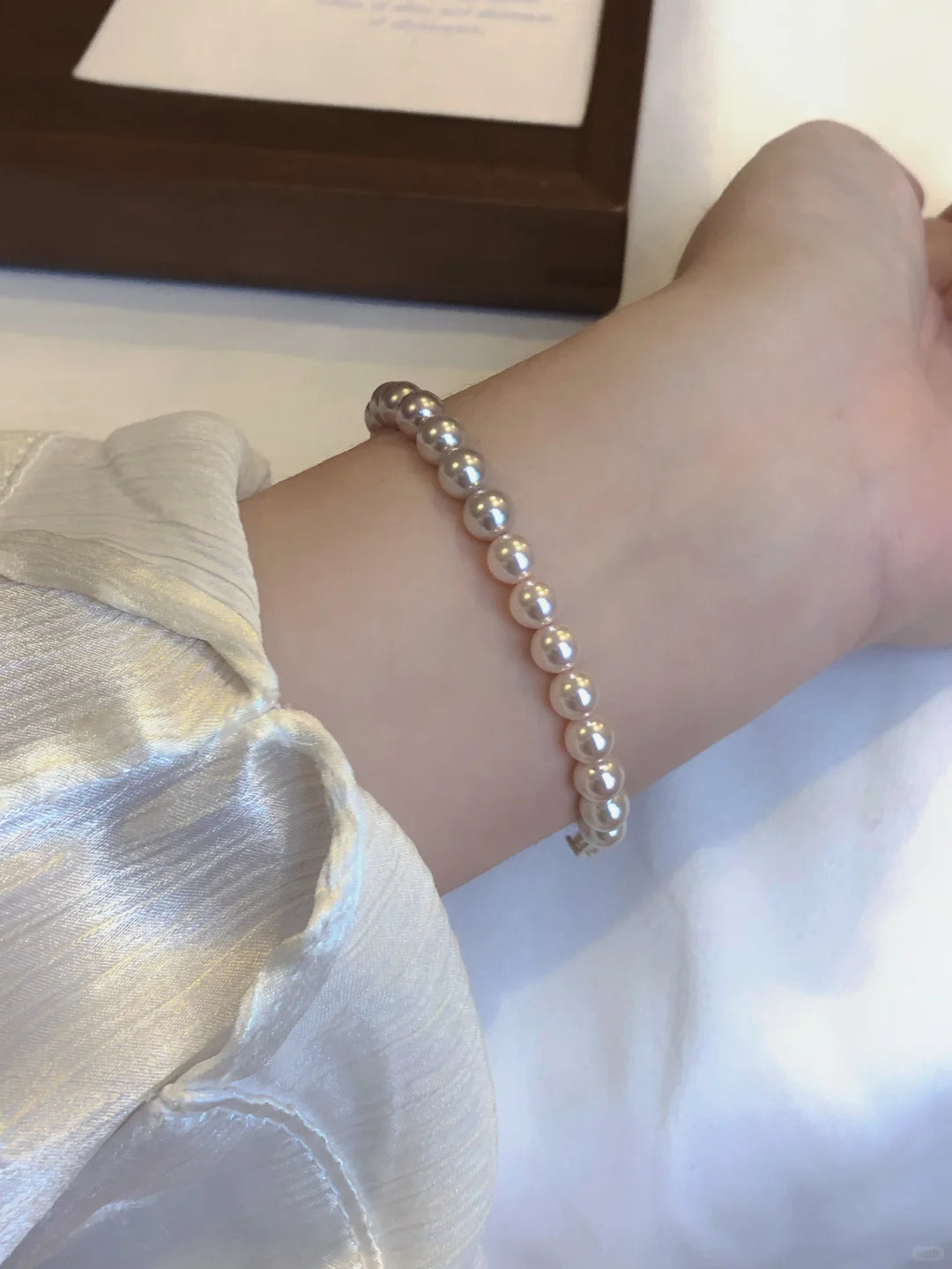 Styled view of classic strand high-lustre freshwater pearl bracelet for bridal styling