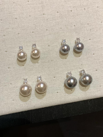 Front view of halo drop high-lustre freshwater pearl earrings for wedding guest looks