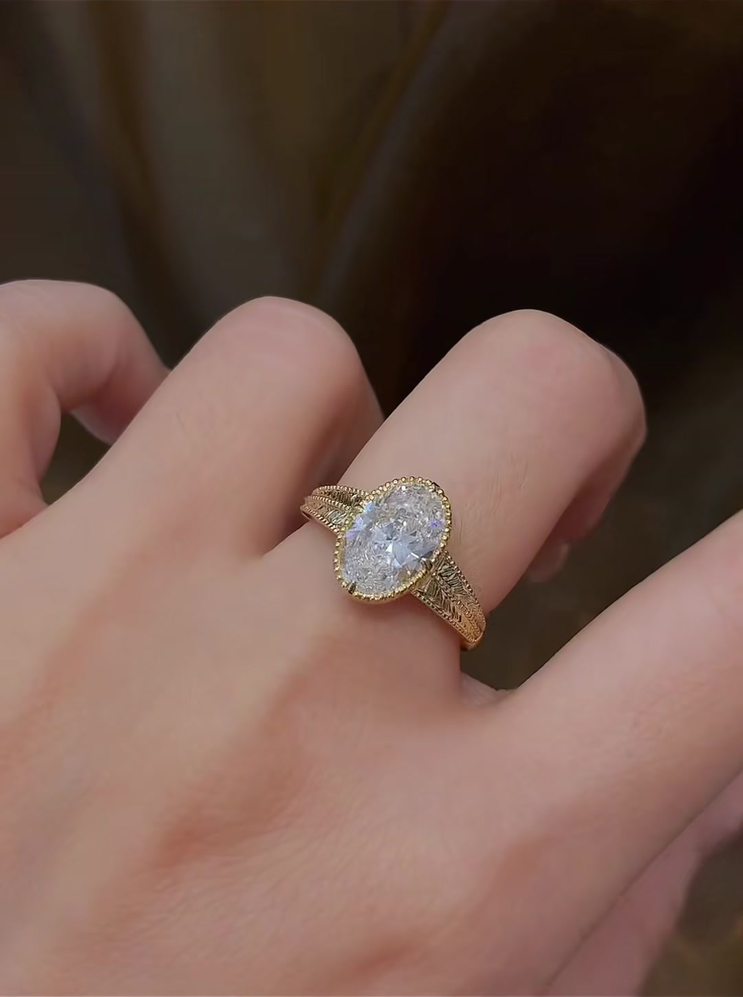 Close-up of lab-grown diamond engraved oval vintage ring for romantic proposals
