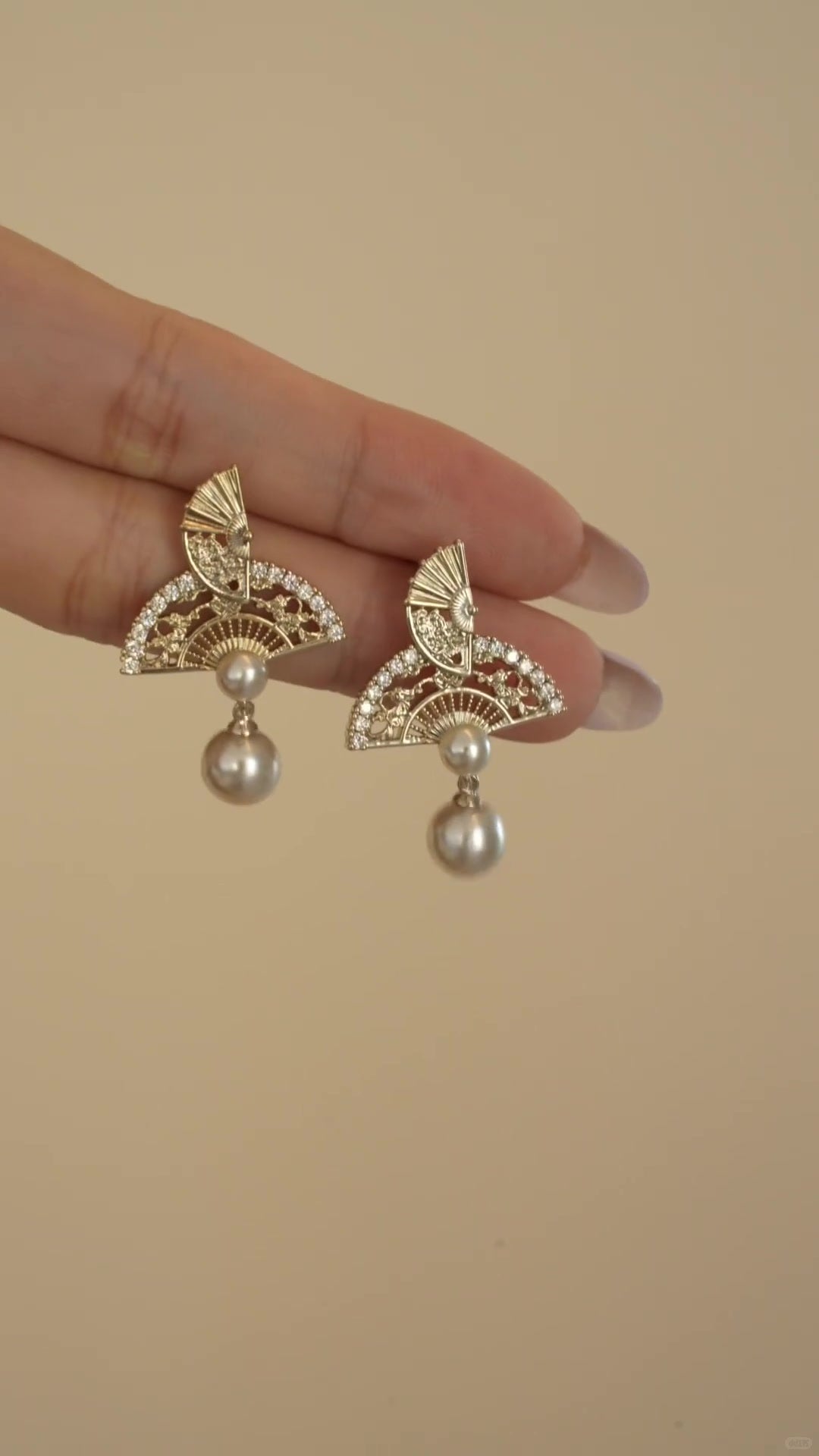 Front view of ornate drop high-lustre freshwater pearl earrings for wedding guest looks