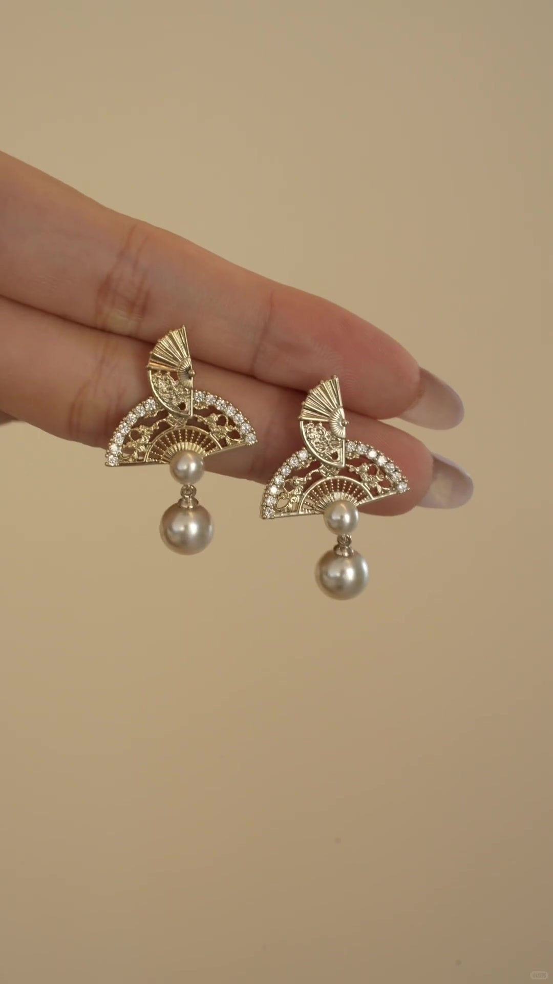 Styled view of ornate drop high-lustre freshwater pearl earrings for wedding guest looks