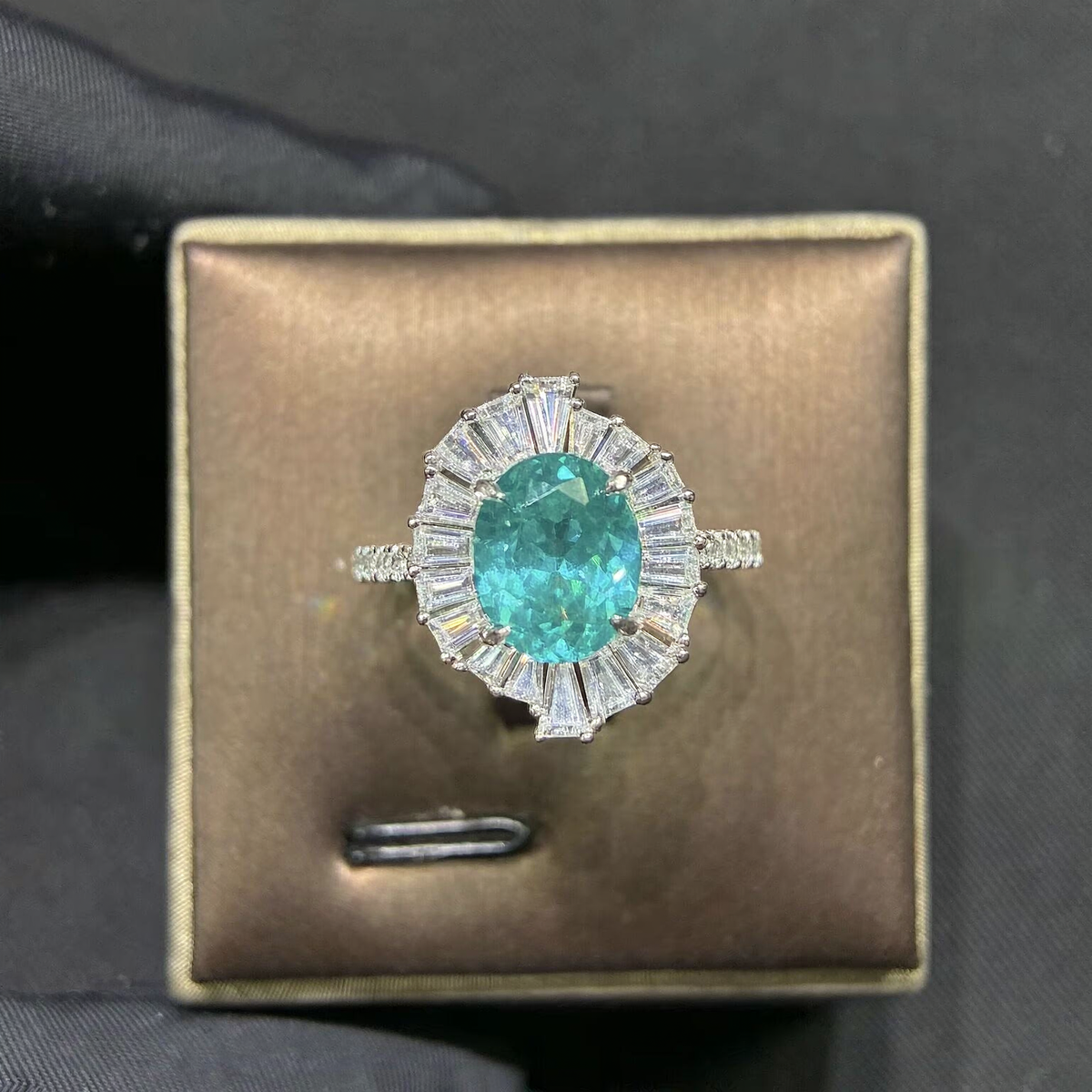 Front view of oval lab-grown Paraiba gemstone baguette halo ring for engagement celebrations
