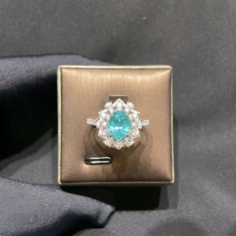 Front view of oval lab-grown Paraiba gemstone mixed-cut halo ring for engagement celebrations
