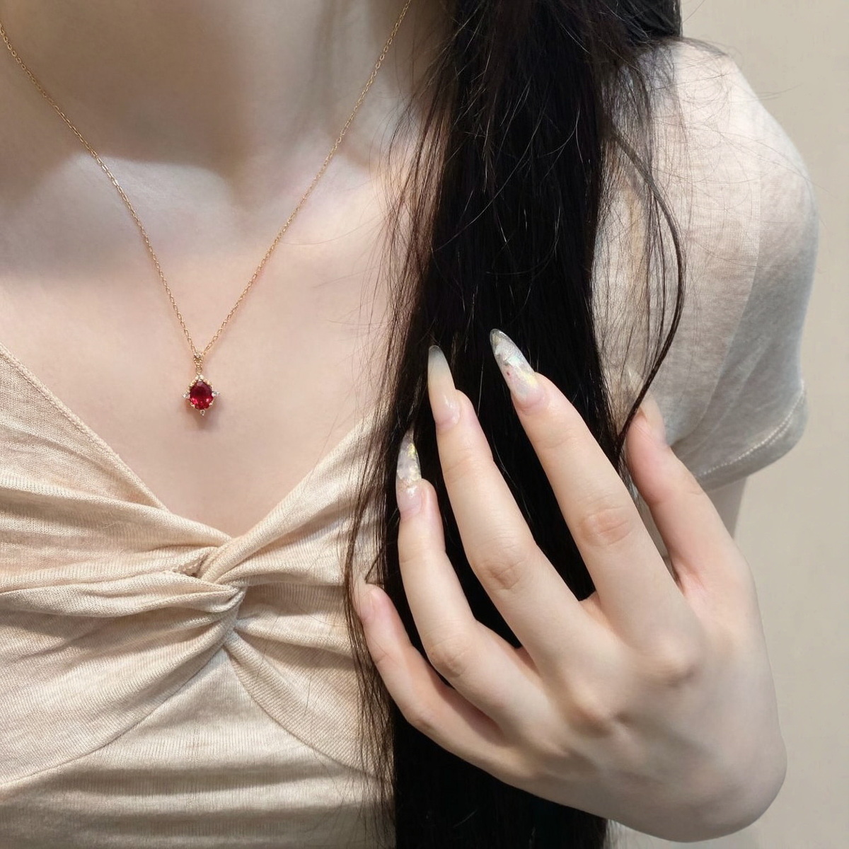 Styled view of oval lab-grown ruby pendant necklace in 16K gold for anniversary gifts