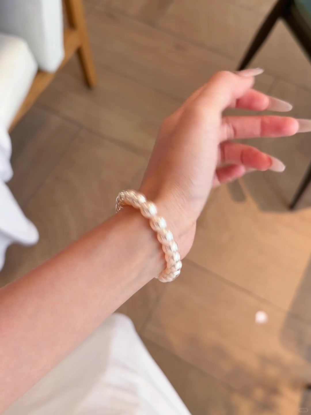 Styled view of blush strand high-lustre freshwater pearl bracelet for bridal styling